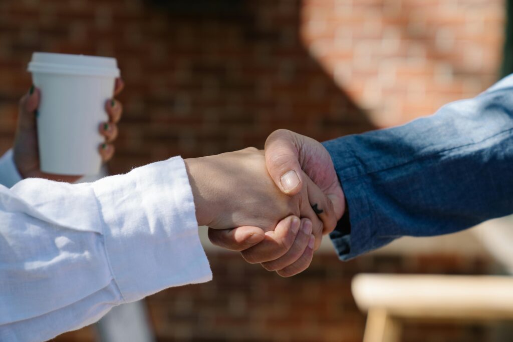 Close-up of two people shaking hands.